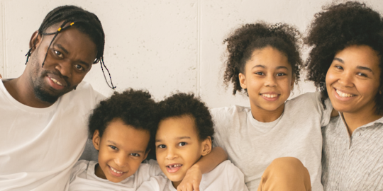 A family of five with a man, woman, and three children