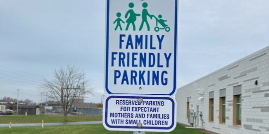 photos of a building with family friendly parking signs in front of the entrance 