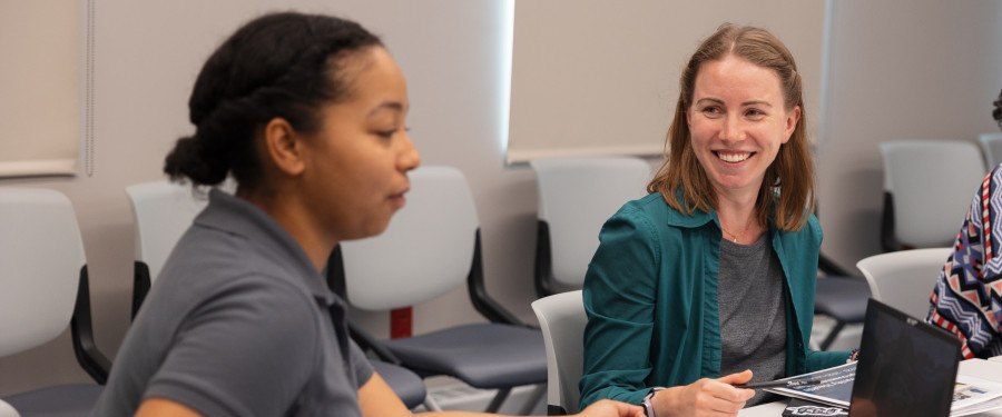 Two women discuss in a meeting 